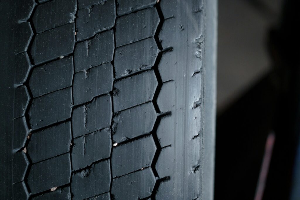 Detailed close-up of a worn tire tread showcasing grooves and patterns.